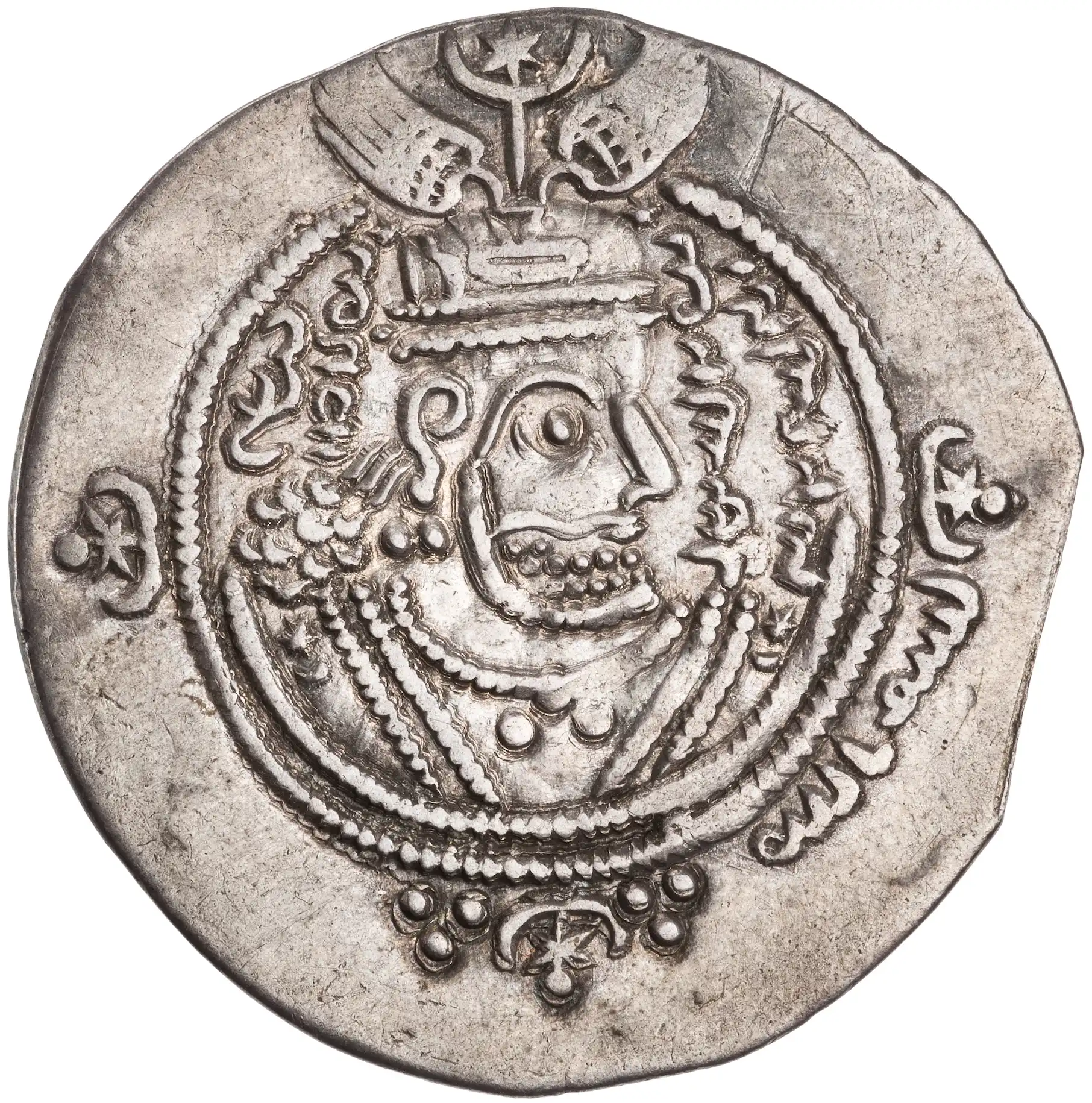 A worn silver coin bearing a stylised crowned royal bust in profile in the Sasanian manner, surrounded by Pahlavi and Arabic inscriptions within a beaded border