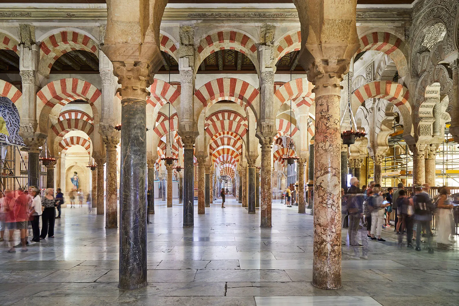 The hypostyle prayer hall of the Great Mosque of Cordoba, rows of columns supporting double-tiered red-and-white striped arches